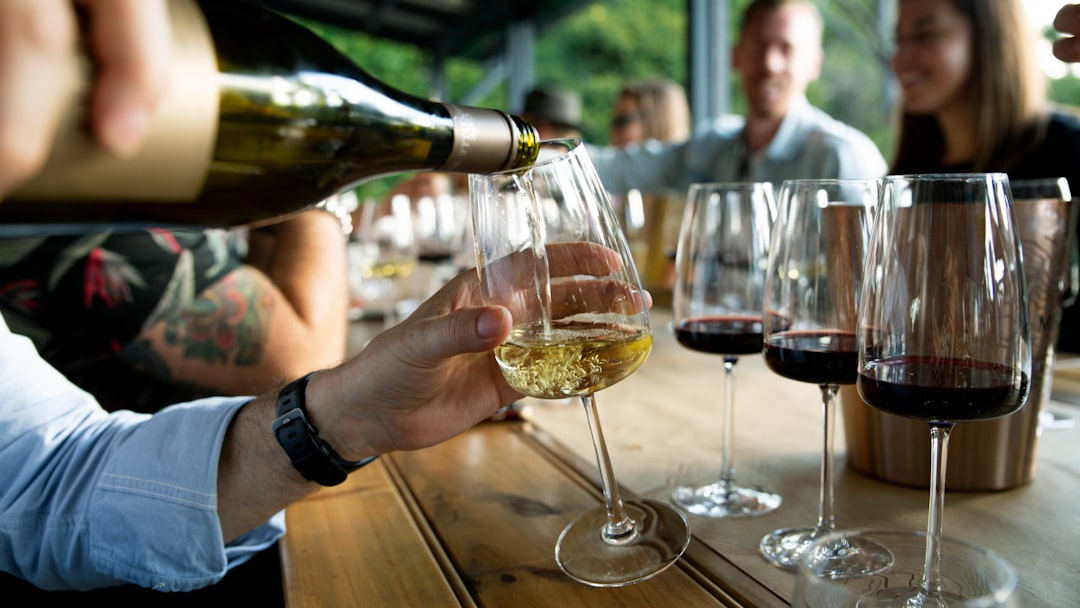A sommelier pours a pairing alongside seasonal summer menus Dubai courses at an elegant restaurant table