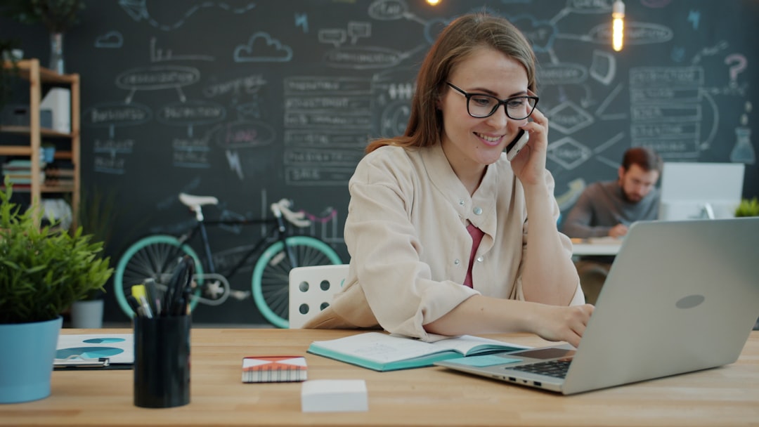 Two founders collaborating on laptops inside a Dubai accelerator programmes coworking space