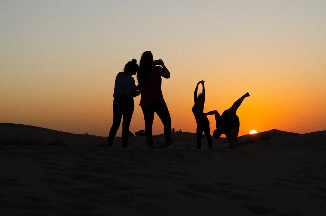 A group of people doing outdoor yoga in a Dubai park during the autumn fitness reset season