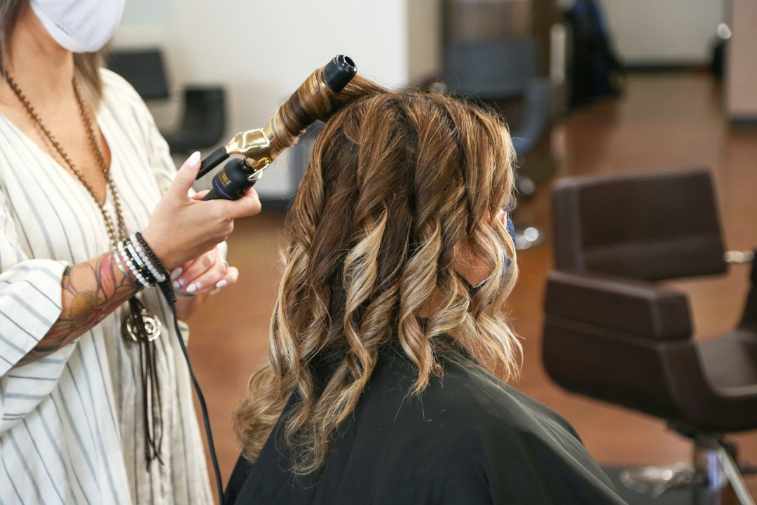 A woman receiving a deep conditioning hair treatment to support her skincare regimen and hair routine as Dubai