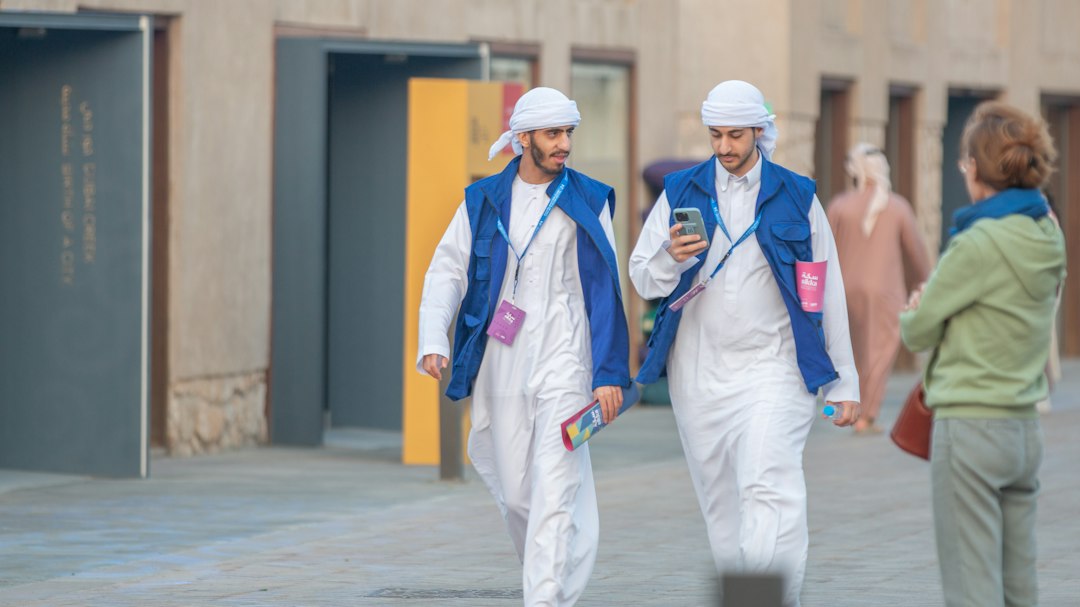 Tourist exploring a Sikka festival installation in Al Shindagha