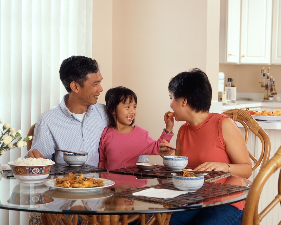 A family sharing rice dumplings together at a table to celebrate Dragon Boat Festival in Singapore