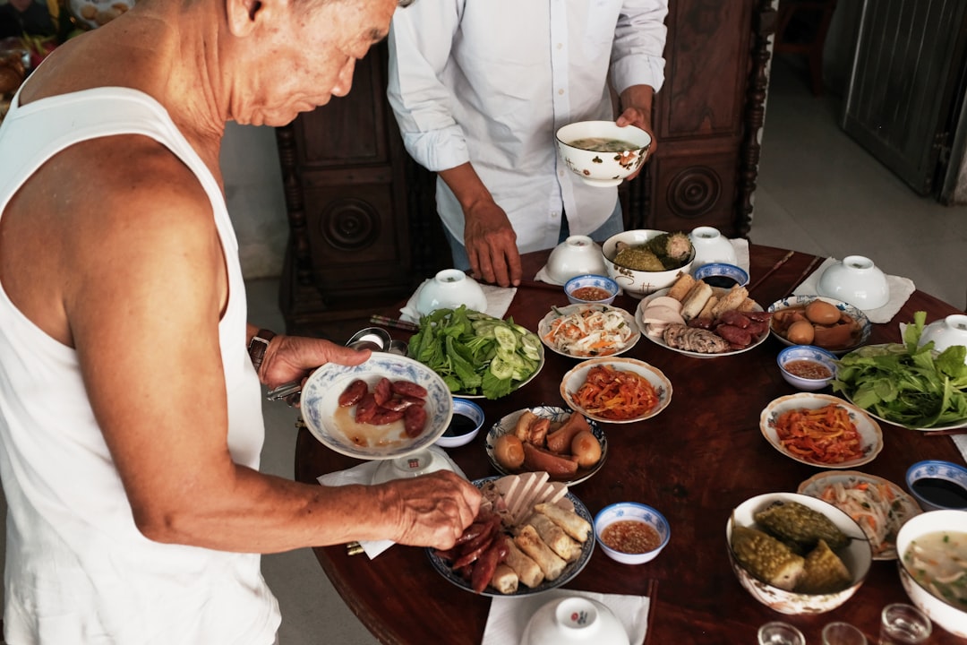A family shares a communal spread of Peranakan cuisine dishes at a traditional Singapore restaurant