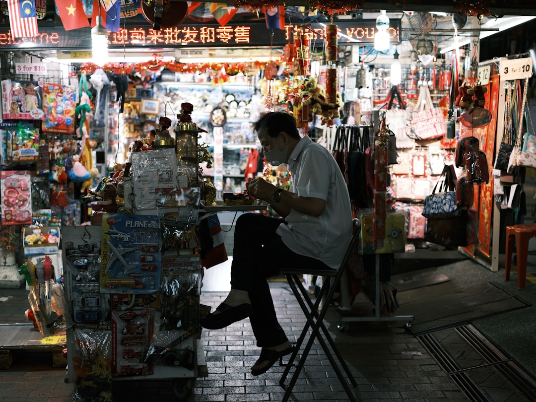 A person enjoys a plate of Hainanese chicken rice, one of the most popular gluten free hawker dishes in Singapore