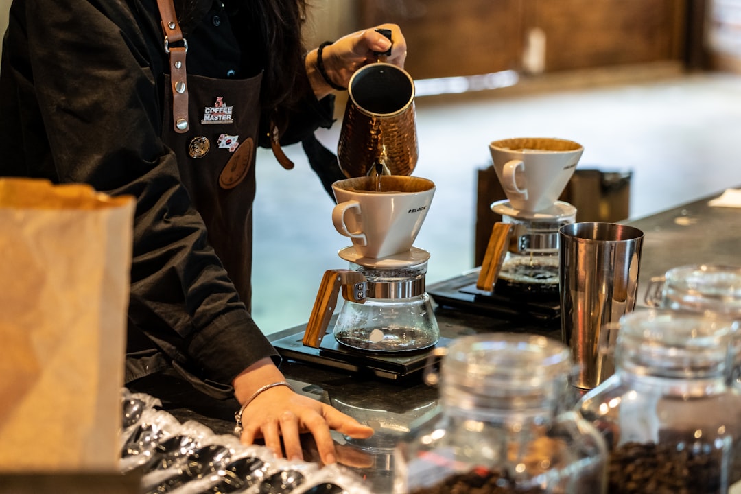 A competitor prepares espresso beverages on stage at a Singapore coffee championship
