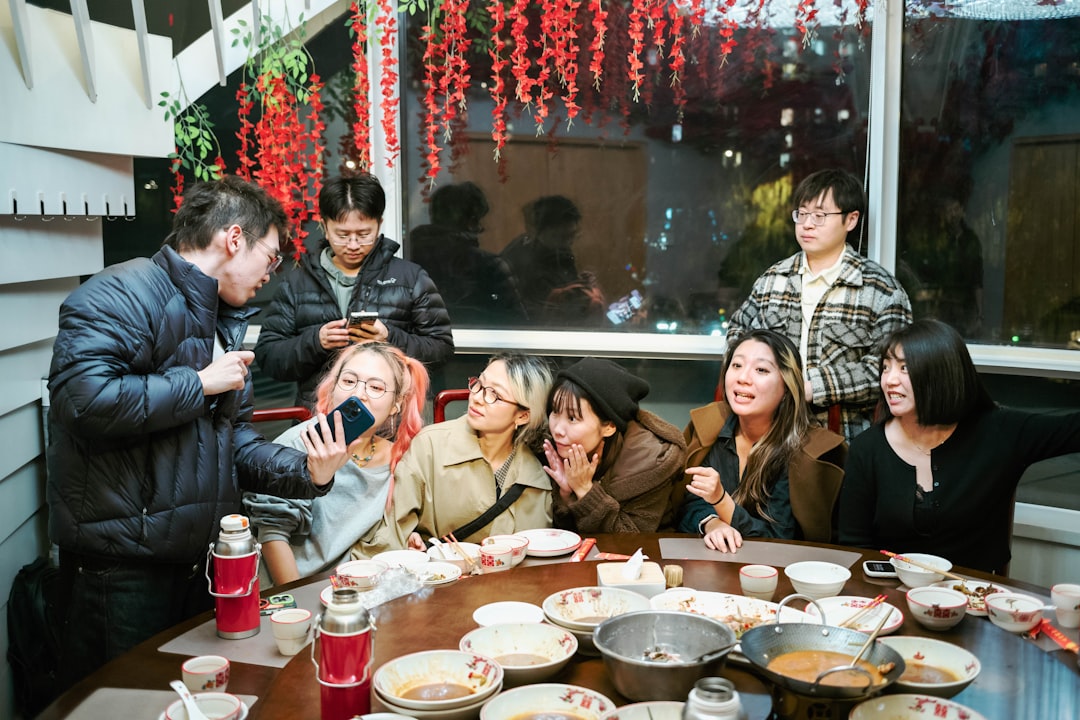 A group of friends sharing plates at a Singapore vegetarian hawker stall during lunch