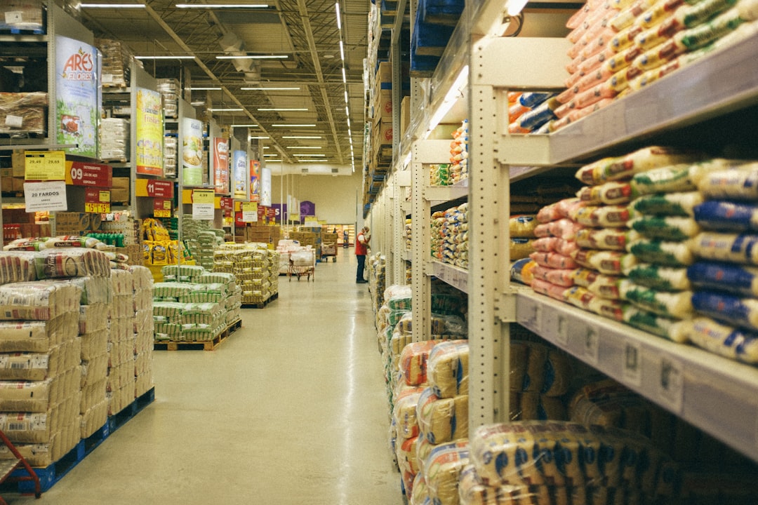 A person filling reusable containers at a bulk food store as part of a household waste reduction routine in London
