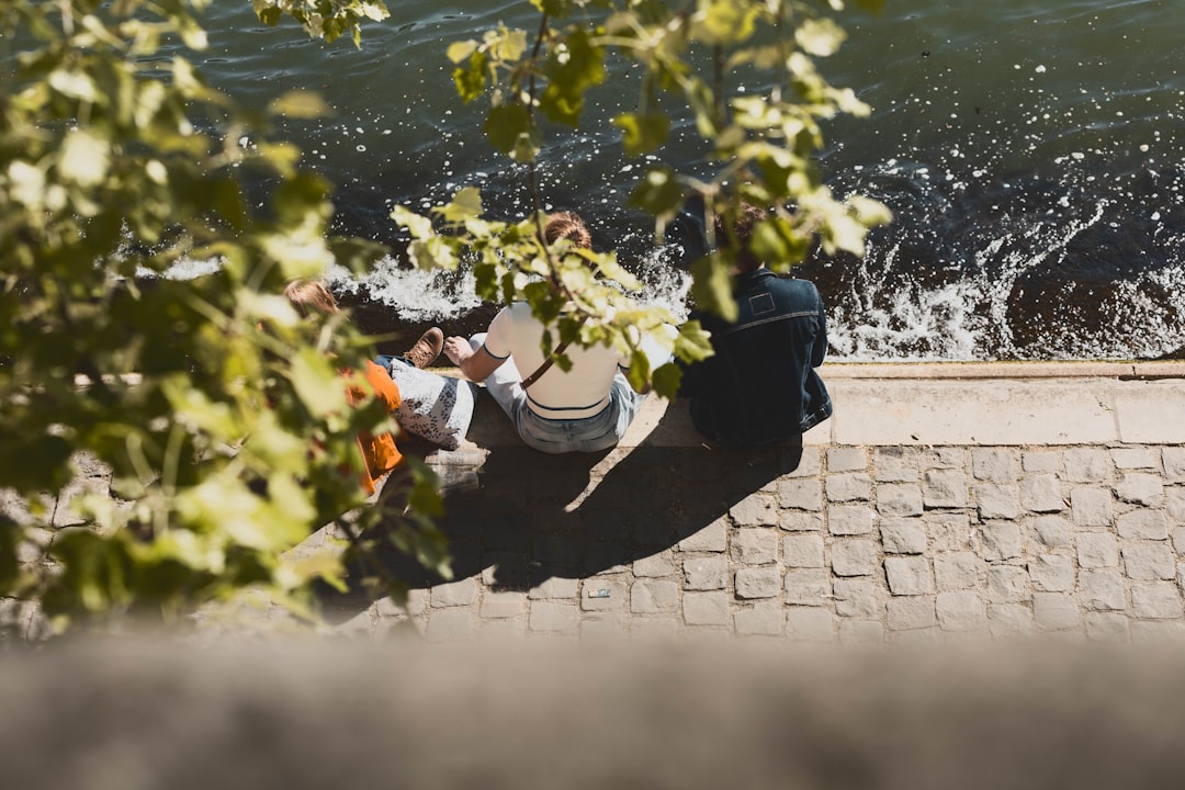 A couple enjoying a Sunday roast with drinks at a riverside in London