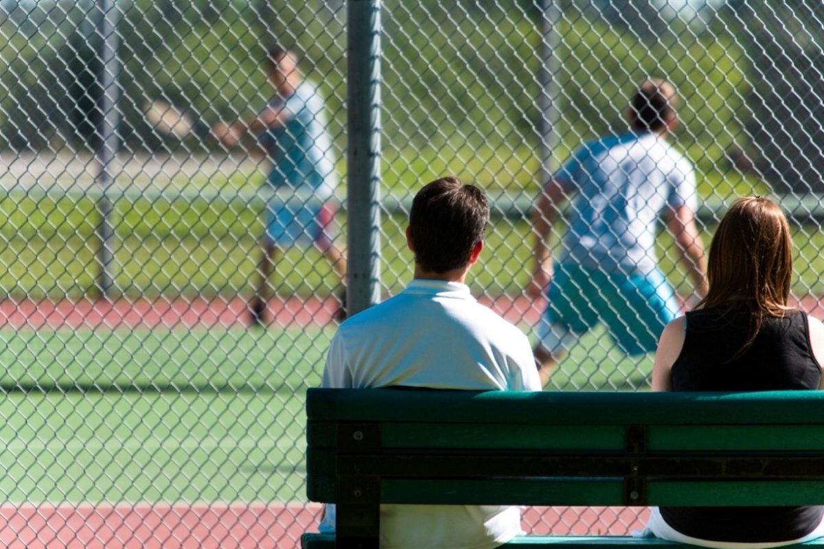 A group of friends cheering at an outdoor screen, following this Wimbledon guide to the best city screenings