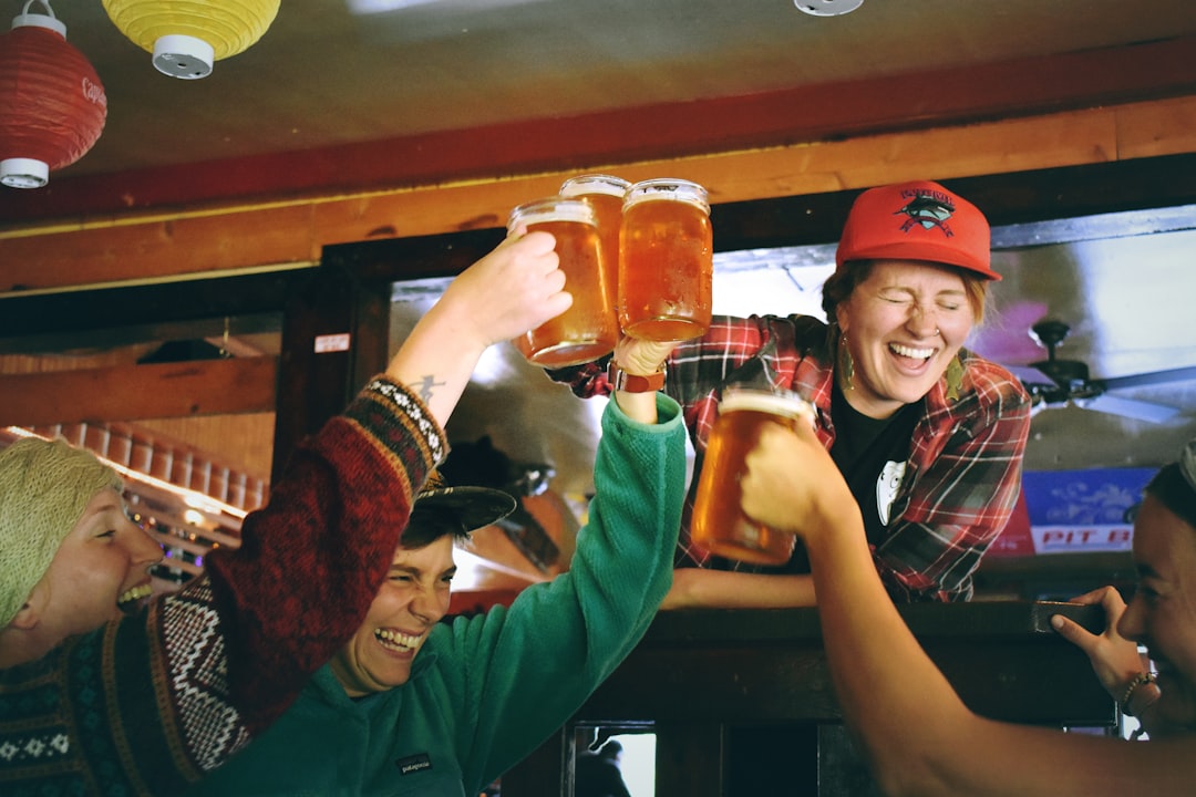 A group of London golf fans celebrating a birdie while watching live streaming of the Open Championship