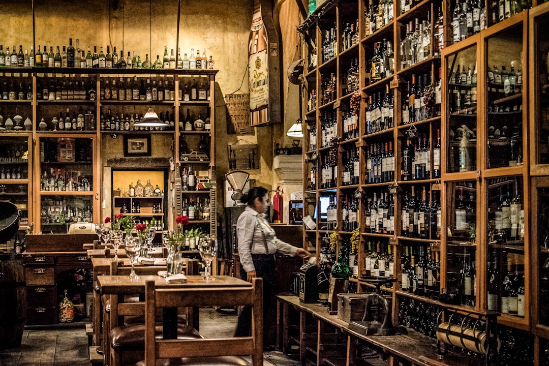 A man selecting bottles in the cellar of a members clubs focused on fine wine in London