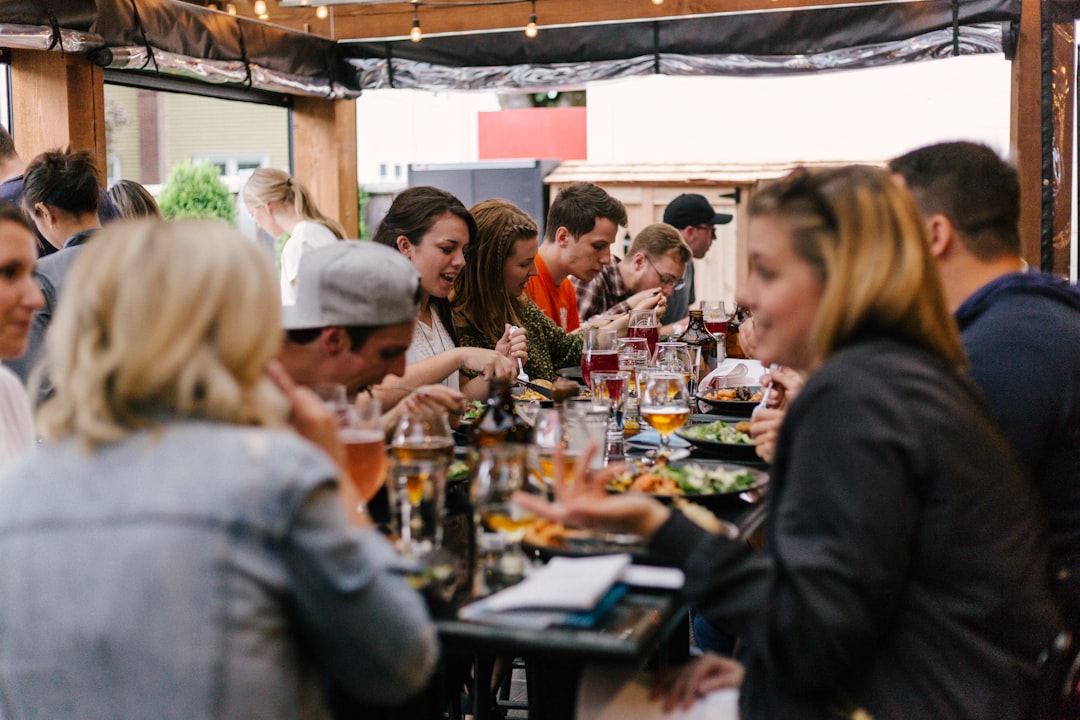 A group of friends sharing dishes on an outdoor restaurant terrace during a London summer evening in Shoreditch