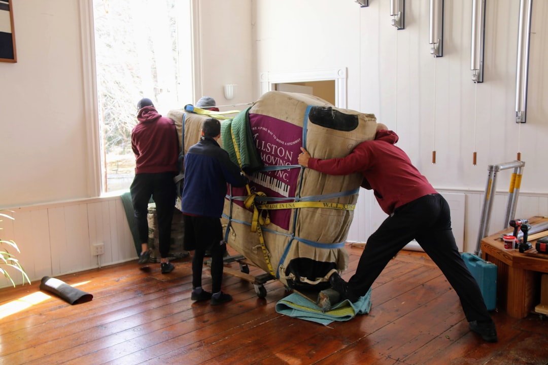 A man donating a sofa to a London charity shop, supporting the ethical furniture circular economy.