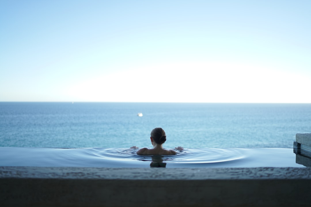 A woman using spa facilities at one of London's rooftop pools, accessed via a hotel day-pass package