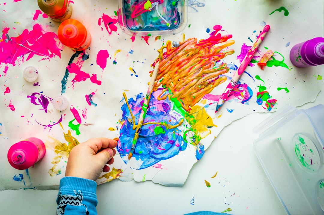 Two children take part in a creative workshop at a free venue in London, surrounded by colourful artworks and displays.