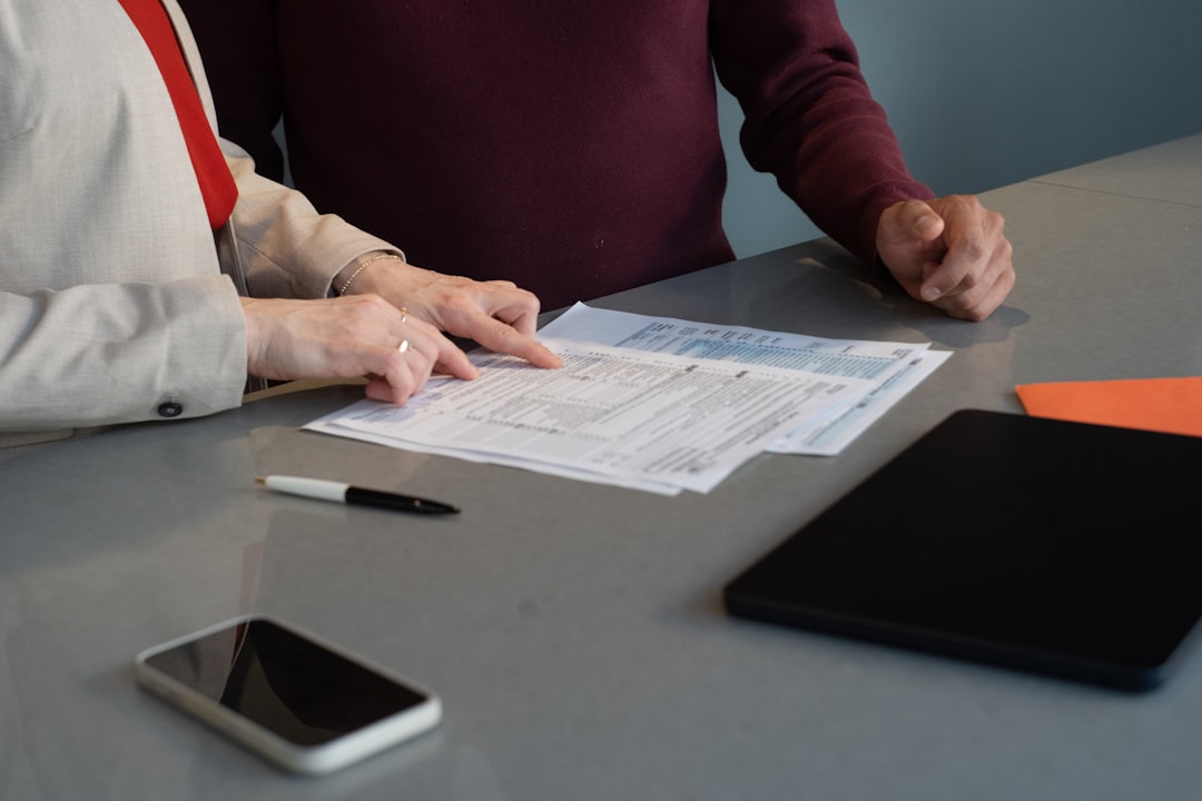 A startup team in a London workspace reviews metrics ahead of their London accelerator deadline