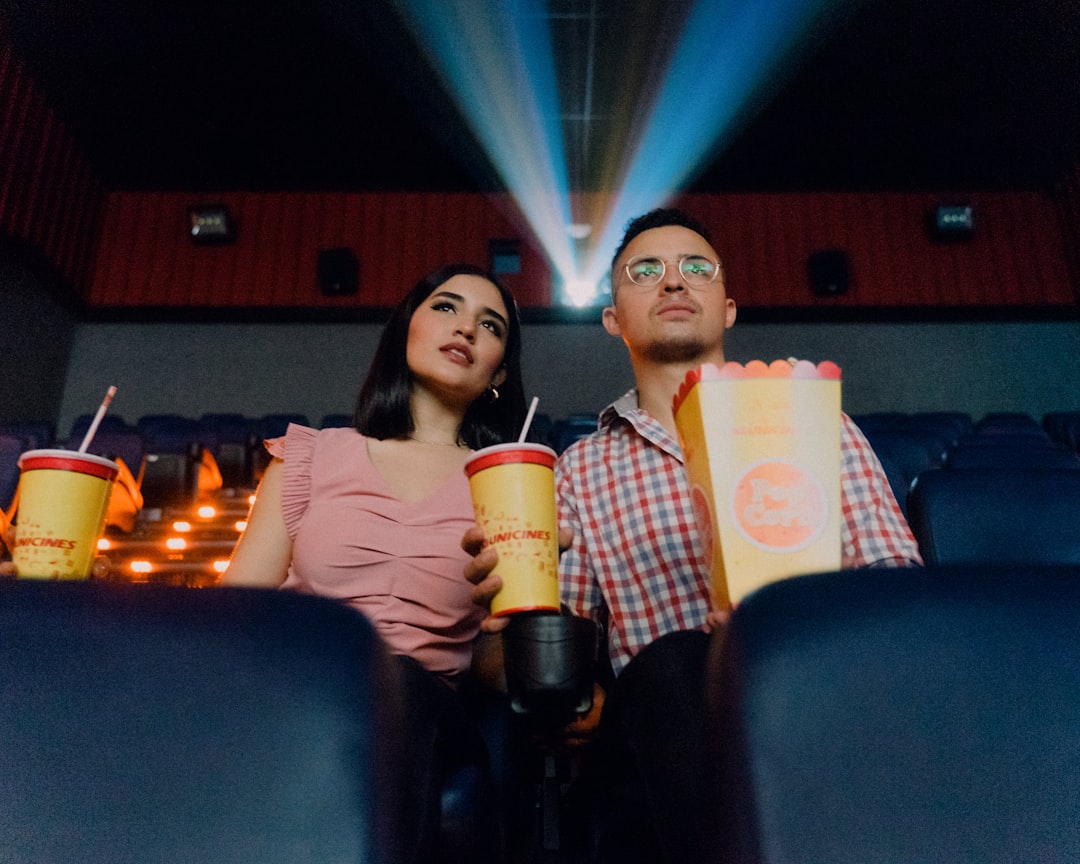 A couple seated together in a dark auditorium enjoying a screening at one of London's independent London cinemas