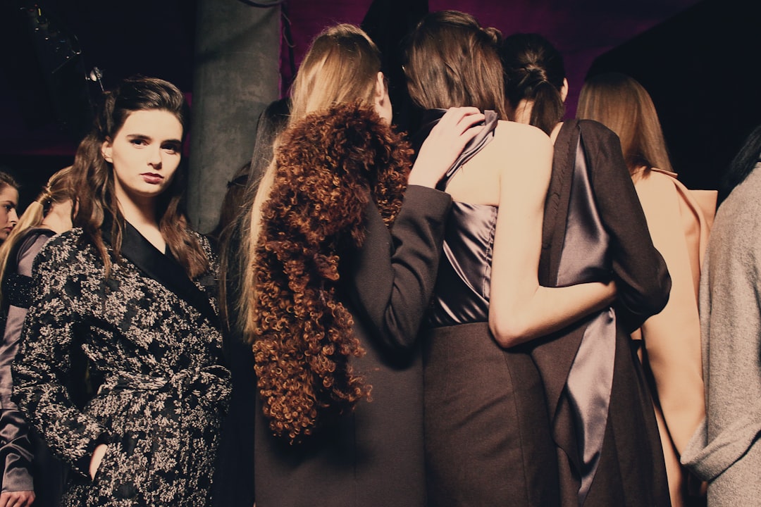 A model dressed in an ethical slow-fashion collection backstage, reflecting the sustainable fashion values at Fashion Week.