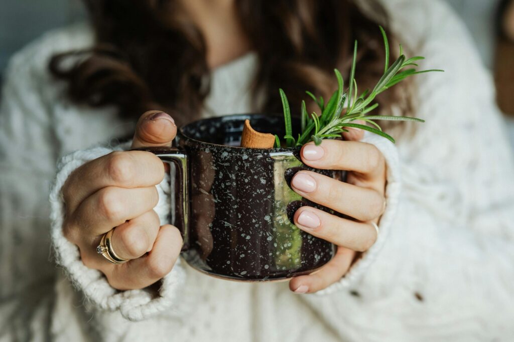 Danish hygge practices for winter wellness showing woman with warm beverage in comfortable nordic home setting 1