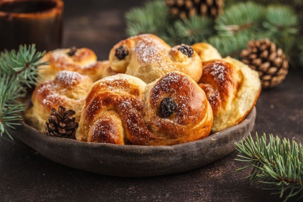 Traditional Swedish lussekatter saffron buns served during St. Lucia Day and winter solstice feasts in Scandinavia, representing golden sunlight returning after darkest winter nights