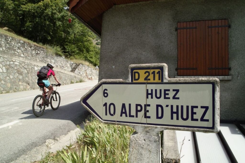 Cycling fans lining the famous hairpin bends of Alpe d'Huez during Tour de France 2026 stages 19 and 20