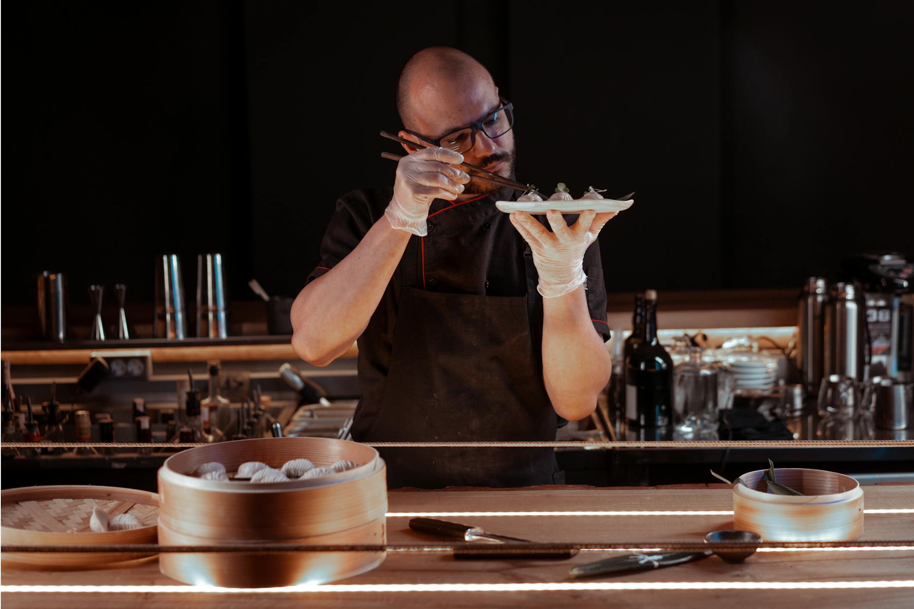 A chef in a Paris kitchen preparing a gluten-free Paris dish with fresh ingredients on a clean prep surface