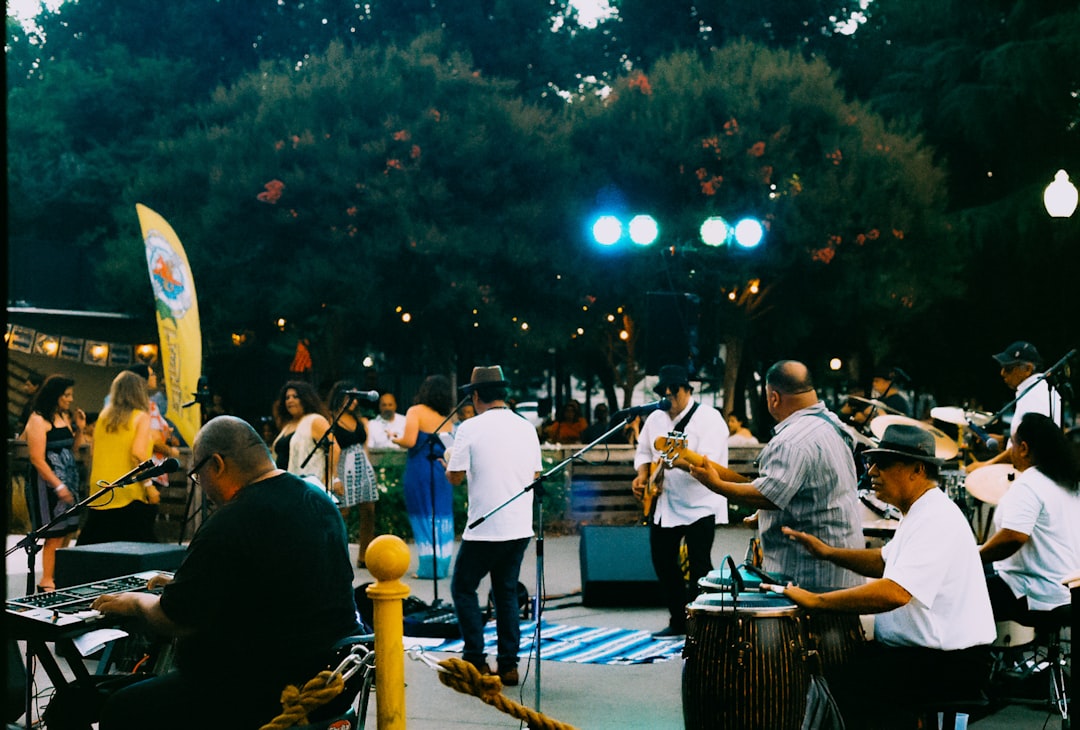 Performers and audience members gathering at the Fest stage of the NEB Festival in a European city park