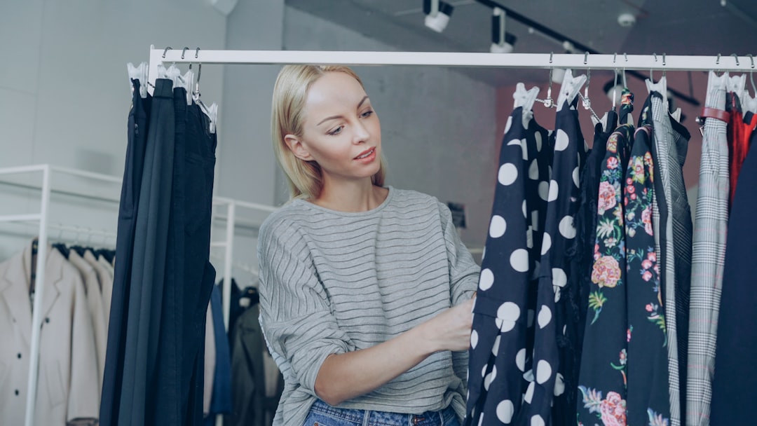 A shopper browses EU Ecolabel clothing options in a clean retail space focused on certified sustainable fashion