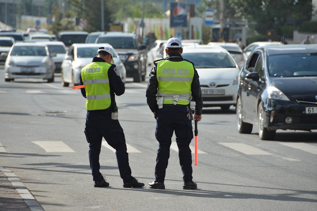 officers conducting a roadside compliance check on drivers under the new EU tachograph rules at a border corridor