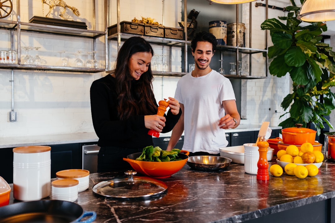 A couple preparing certified gluten-free pasta together in a bright, modern home kitchen