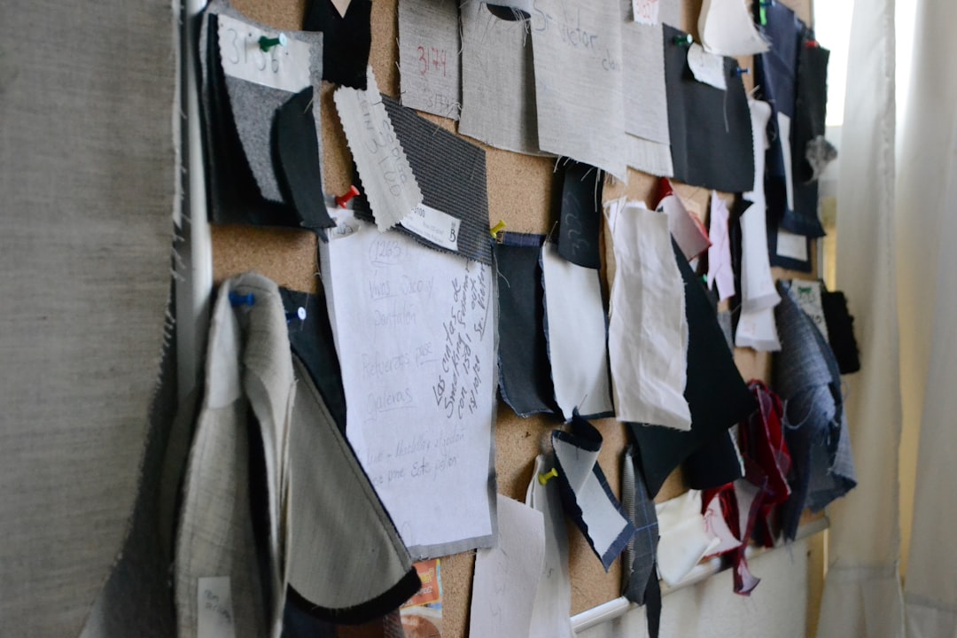 A fashion designer reviews recycled fabric swatches as part of a circular fashion brand's product development process.