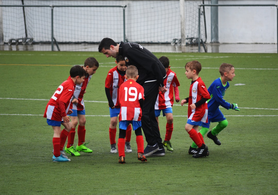 A grassroots coach leads young players in a club training session during the European Week of Sport