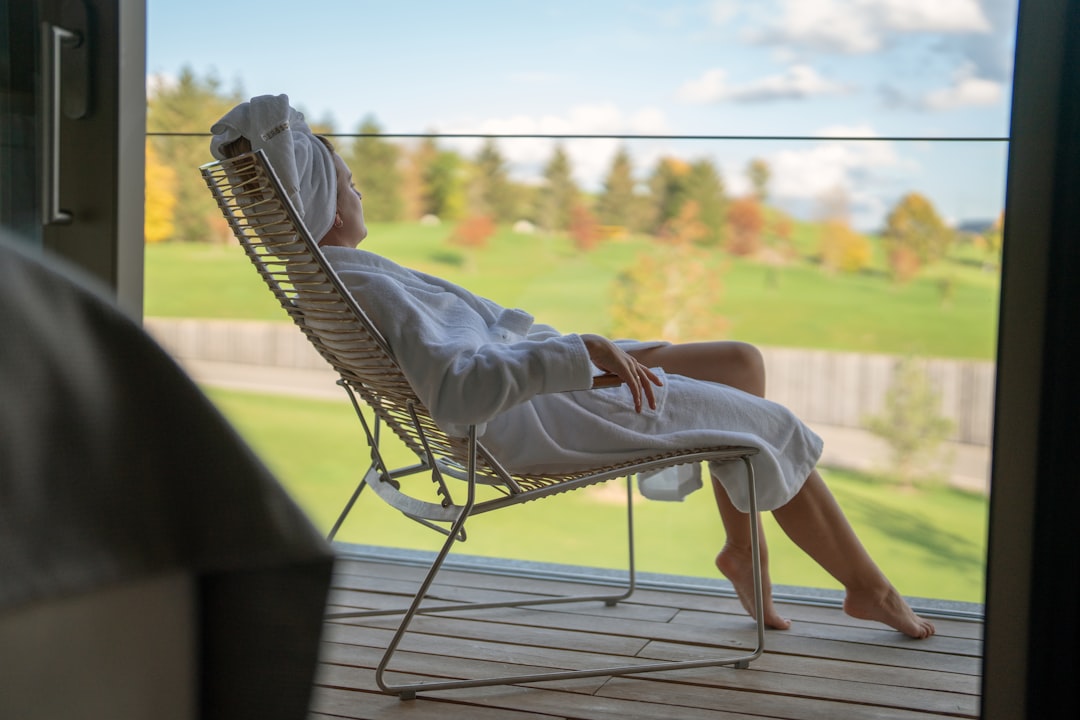 A guest wrapped in a white robe, enjoying the serenity of a coastal thermal retreat in southern Europe.
