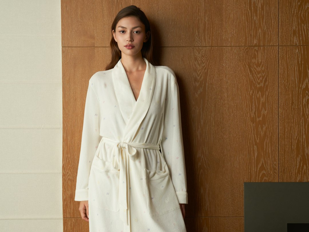 Visitor in white robe during light therapy session at Stockholm café