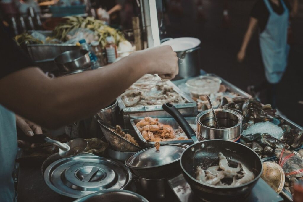 Food tourists enjoying culinary tourism experience at Indian restaurant showing economic impact