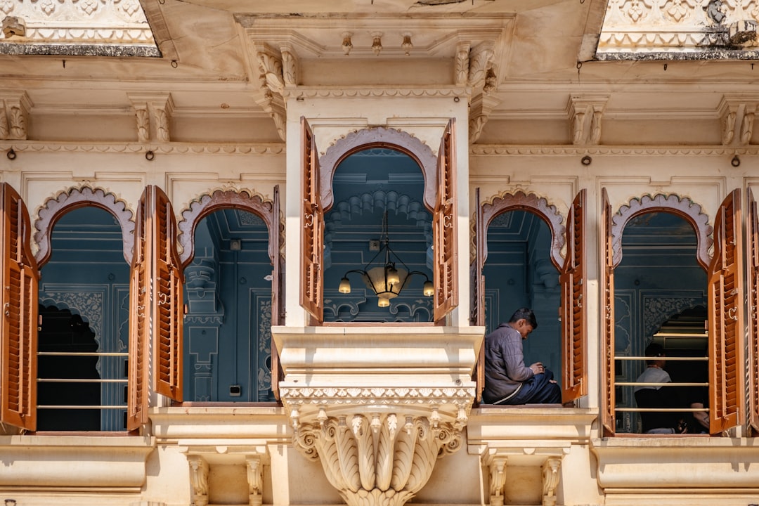 An Indian man performing morning movement as part of his Ayurvedic morning rituals on a sunlit balcony