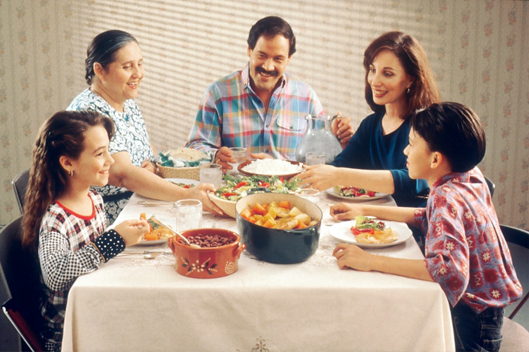 An Indian family shares a meal of monsoon dal and rice at a dining table during the rainy season.