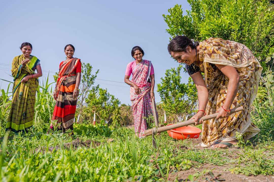 A family in India examining their garden percolation pit used for rainwater harvesting and groundwater recharge