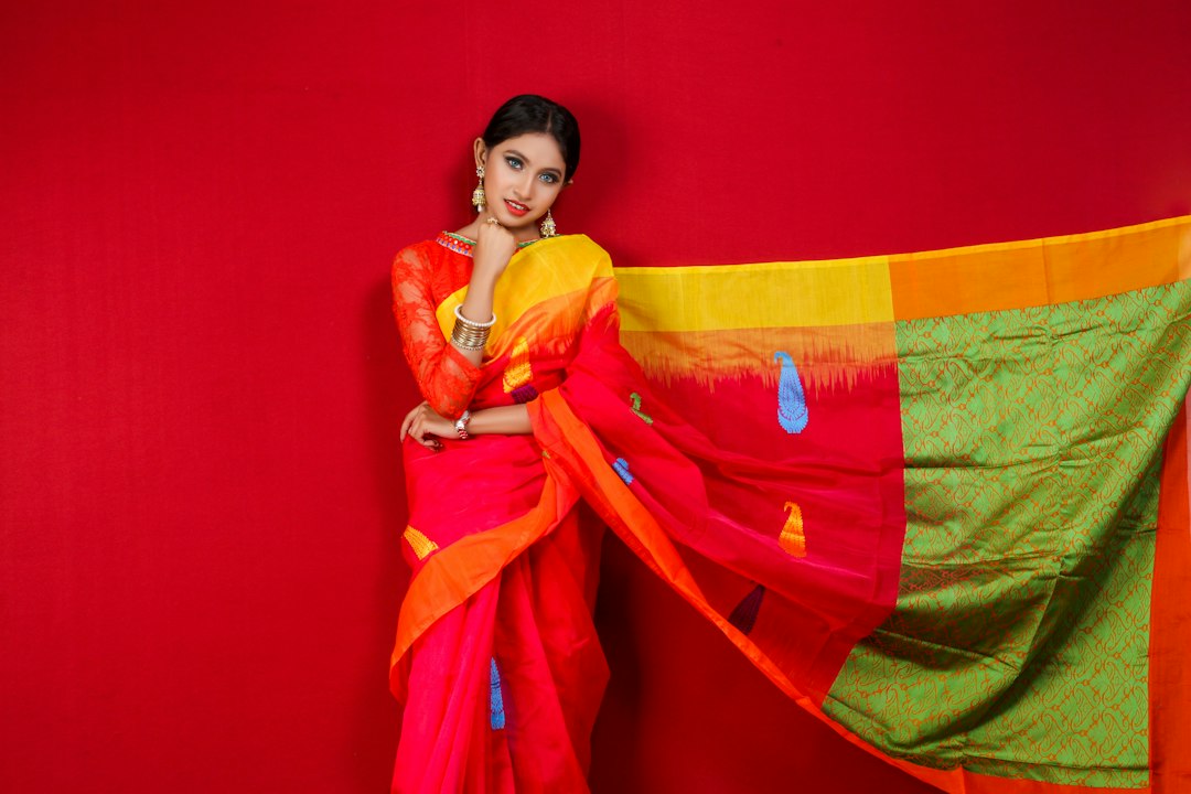 A woman selecting a handloom inventory piece at a festive market, choosing sustainable Indian craft over fast fashion.