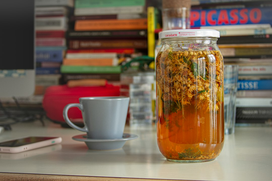 Glass jar of fermented foods like kanji resting in sunlight